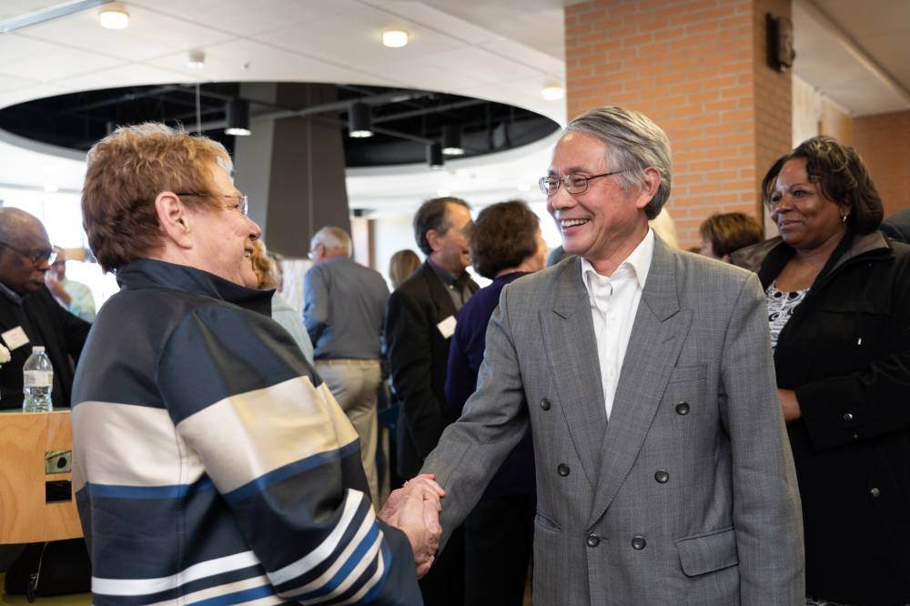 Lynn Blue greeting a guest at the Lynn M. Blue Connection Naming Ceremony